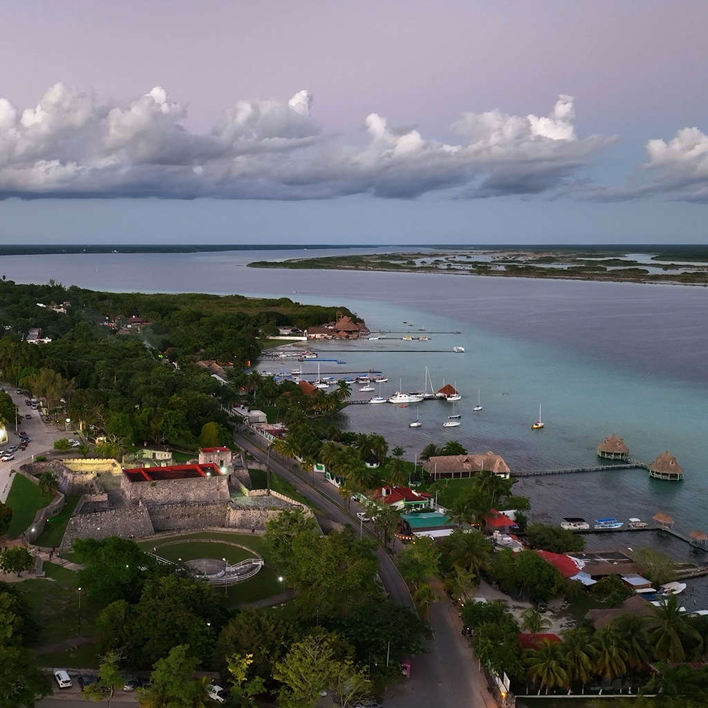 Aerial view of Bacalar's downtown center featuring El Fuerte de San Felipe in the heart of it overlooking the Lagoon of 7 Colors.