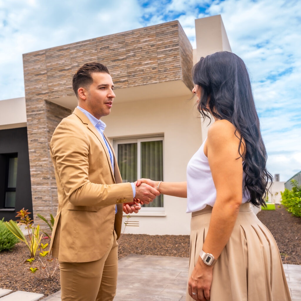 Image of real estate agent showing a house to a client.