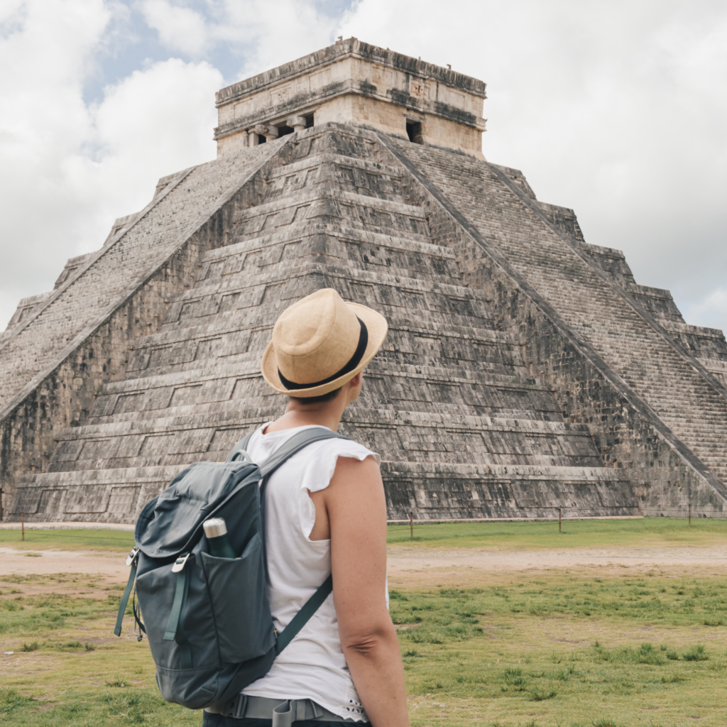 Traveler gazing at the magnificient Chichen Itza Mayan Ruins near Valladolid, Mexico.